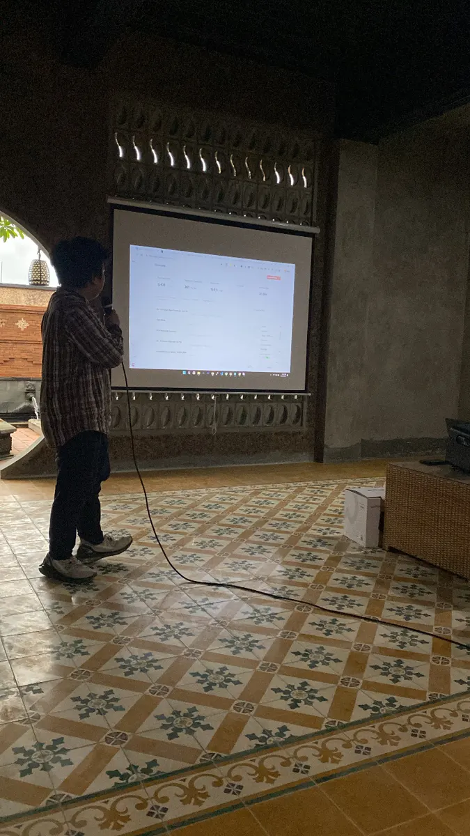 A participant presenting results on the big screen