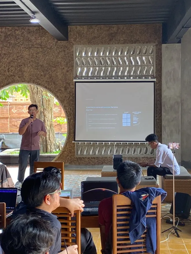 A speaker presenting while the session is filmed