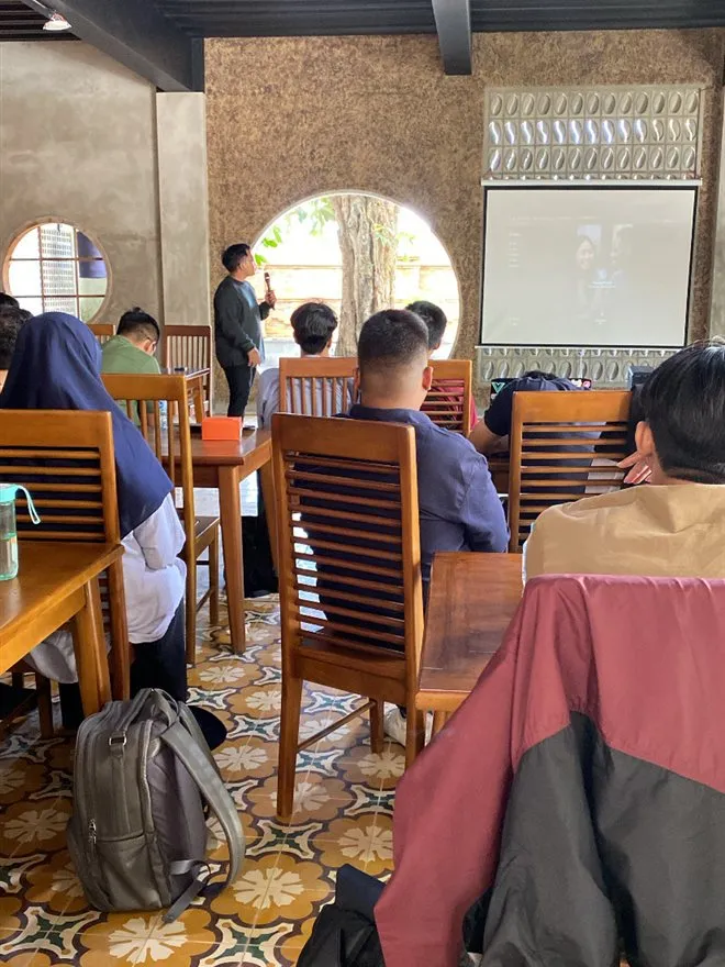 A speaker addressing the room at Hackathon Jogja